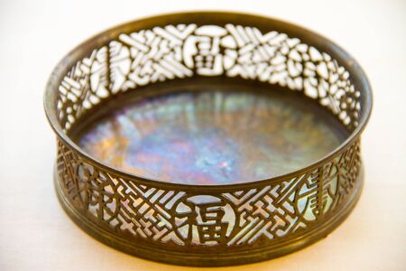 Old brass tray on on white floorの写真素材