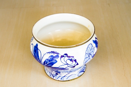old painted pottery bowl on Floor Tilesの写真素材