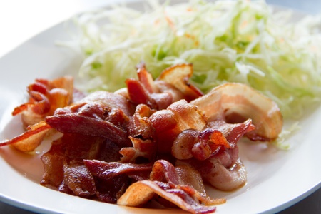 fried bacon on a white plateの写真素材