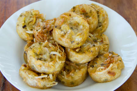 Fried pastry dough on white dishの写真素材