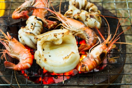 Seafood barbecue of grilled Shrimps and squid on charcoal ovenの写真素材