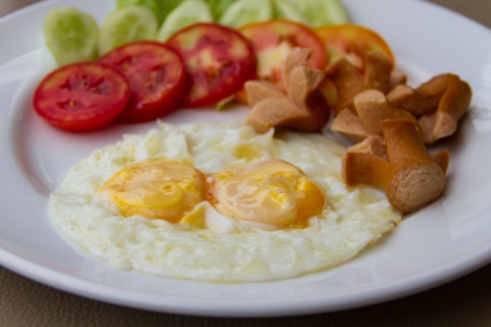 Fried eggs with sausage and and vegetablesの写真素材
