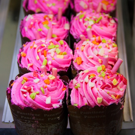 Rows of cup cakes placed on shelvesの写真素材