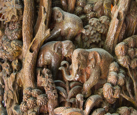 Wood carved elephants on the wallの写真素材
