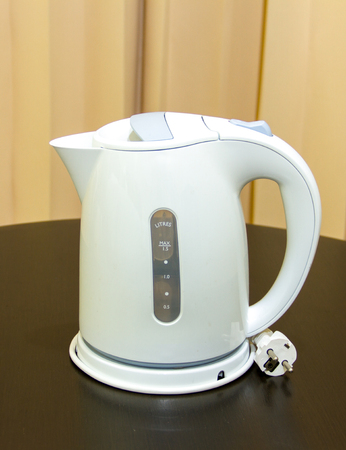 Electric kettle placed on a wooden tableの写真素材