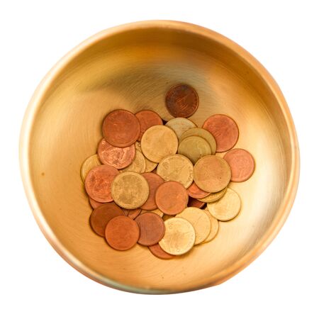 coins in a brass bowlの写真素材