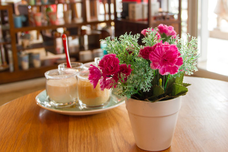 Potted flowers on a table in a cafeの写真素材