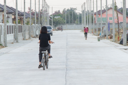 Women cyclists in the villageのeditorial素材
