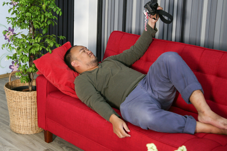 Fat man in the living roomの写真素材