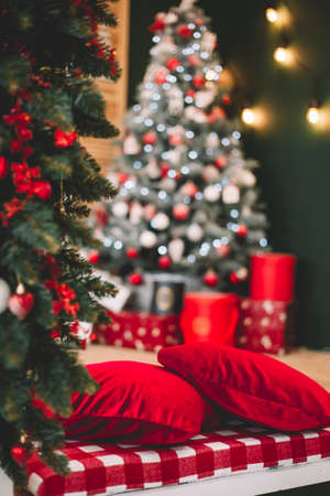 Christmas decorations red pillows on a background of blurred in focus Christmas treeの写真素材