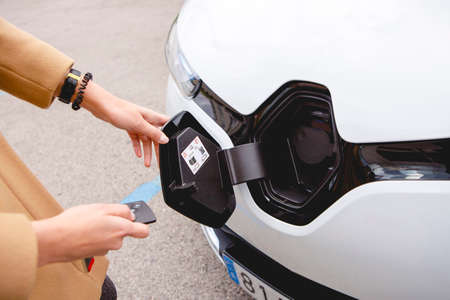woman ready to charge an electric car