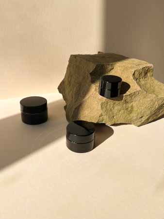 Set of black cosmetic containers on white background.