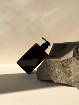 A bottle on a white background with a shadow from the sunの写真素材