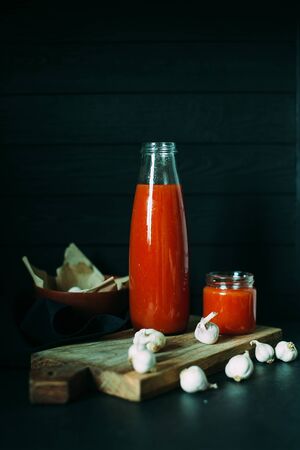 Tomato juice in a jar with a chapel on a wooden boardの写真素材