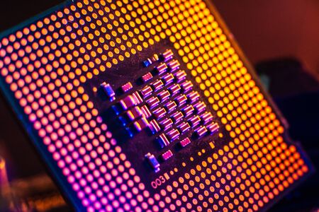 Processor with neon light. Large photo with blue-yellow light on a dark background.