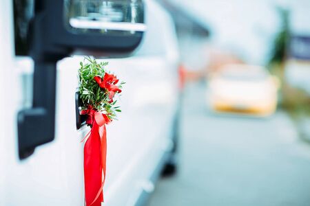 Wedding decor of limo handles. Flowers and grass on a car handleの写真素材