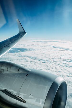 Wing of an airplane against a background of dense clouds