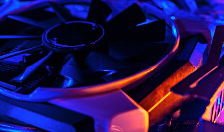 Graphics card in neon light. Cooling in a computer. Fan blade