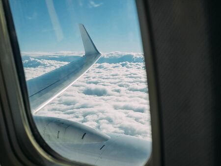 Wing of an airplane against a background of dense clouds