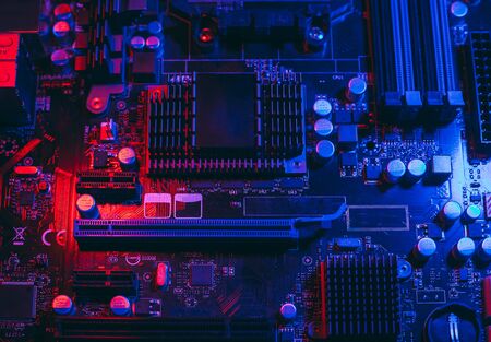 Hardware technology concept in neon light. Motherboard in blue-red light. Computer  component. Dark...