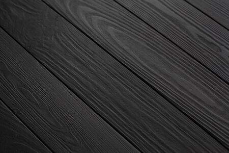 Black embossed wood texture. Dark wooden background. Wood texture close up. Wood planksの写真素材