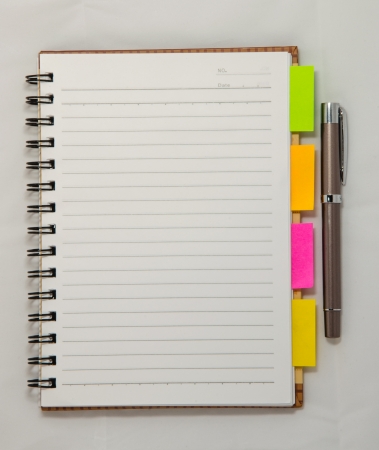 notebook and pen isolated on whiteの写真素材