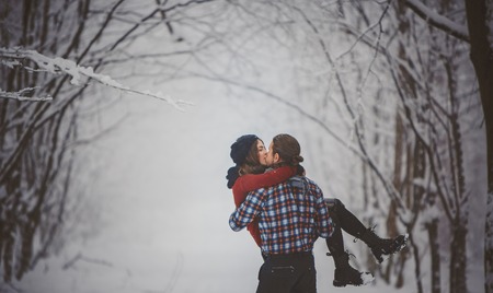 Winter fun couple playful together during winter holidaysの写真素材