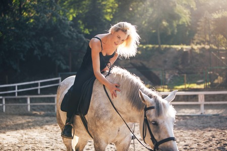 Young Girl Riding Her Horse outdoorの写真素材