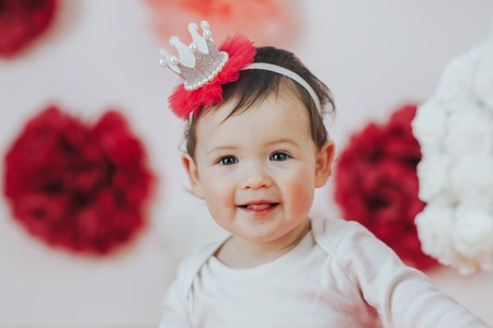 Celebrating the first birthday. Happy little princess at pink girls partyの写真素材