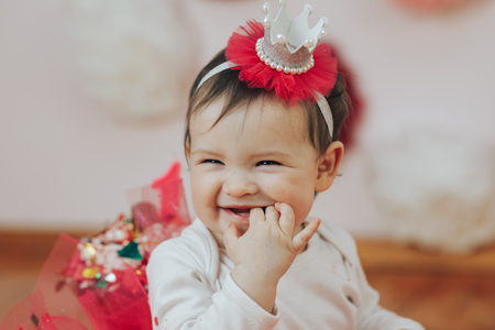 Celebrating the first birthday. Happy little princess at pink girls partyの写真素材