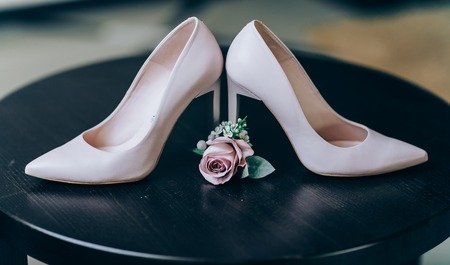 Bridal morning details composition. Wedding bouquet of pink flowers, boutonniere and leather shoesの写真素材