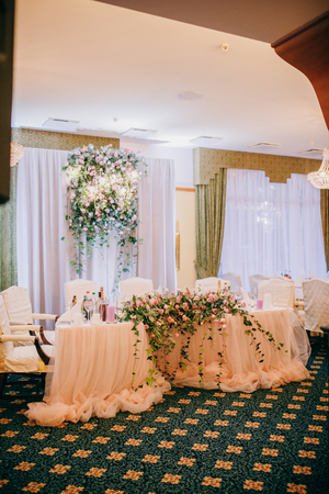 Table for the newlyweds. Wedding reception. Elegant wedding table arrangement, floral decoration, restaurantの写真素材