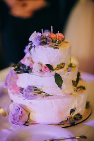 White wedding cake with flowers and blueberriesの写真素材