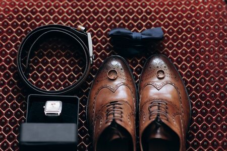The groom is gathering in the morning. Men's classic patent leather shoes. A bow tie. Wedding details. Watch with leather strap.の写真素材