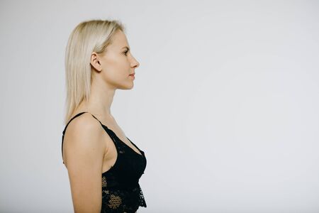 Blonde model in black lingerie isolated on white backgroundの写真素材