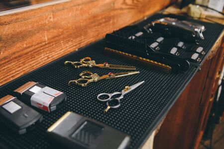 Professional hairdressing tools. Comb, scissor, clippers and hair trimmer isolated.