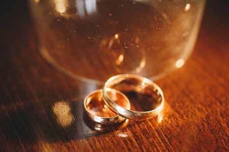 Golden wedding rings. Two golden wedding rings isolated on the table, wedding rings background...