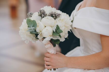 Beautiful wedding bouquet in hands of the brideの写真素材