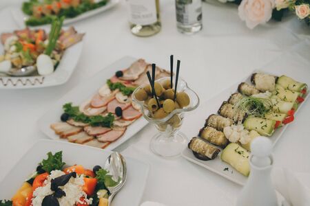 Beautifully decorated catering banquet table with cold snacks. Variety of tasty delicious snacks on the table.の写真素材