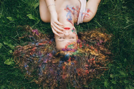 A Young Beautiful Girl Relax At The Green Grassの写真素材