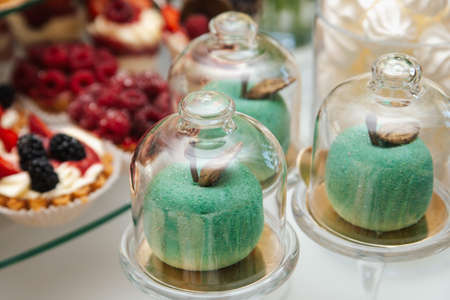 Candy bar at wedding reception. Dessert table for a party. Cake cupcakes sweetness