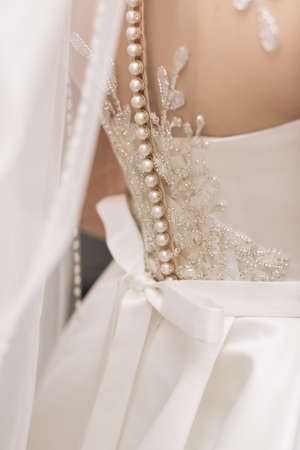 Luxurious wedding dress nearby. Best Wedding Morning. Wedding concept. Beautiful Lace Bridal Wedding Dress with Backの写真素材