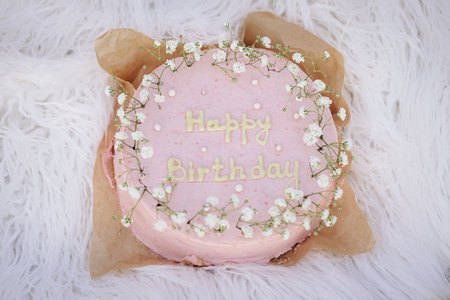 Happy birthday cake. Pink birthday cake over white background.の写真素材