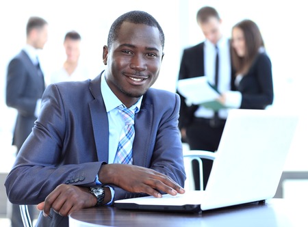 Portrait of a handsome young business man with a laptopの写真素材