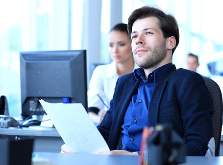 Satisfied businessman relaxing in his office