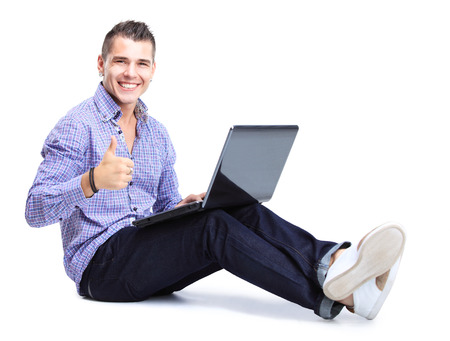 Portrait of happy man working on laptop in casuals - isolated on white  Concept communication の写真素材
