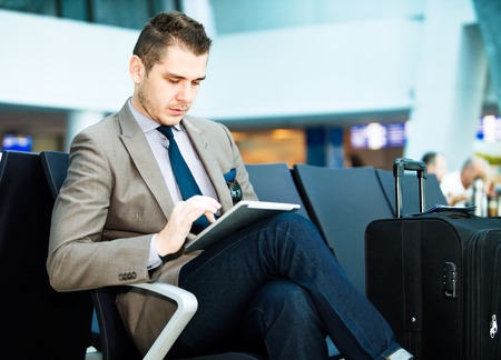 modern businessman using tablet computer at airportの写真素材