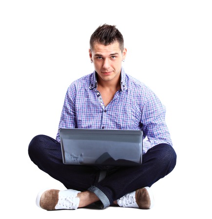 Portrait of happy man working on laptop in casuals - isolated on white. Concept communication.の写真素材