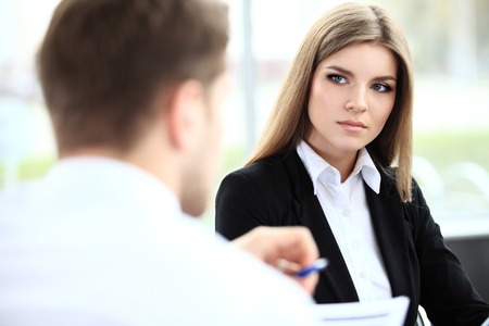 Face of beautiful woman on the background of business peopleの写真素材