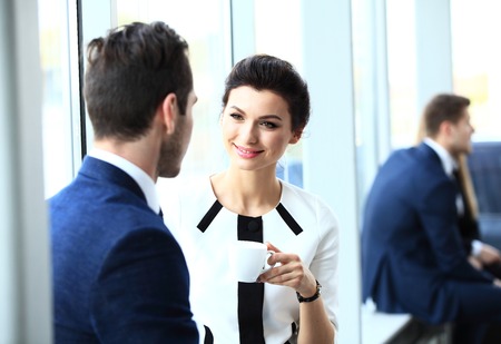 Young couple of professionals chatting during a coffee breakの写真素材